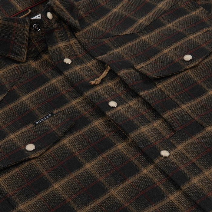Close-up of The John Colter plaid button-up shirt in brown and black tones with snap closures and chest pockets