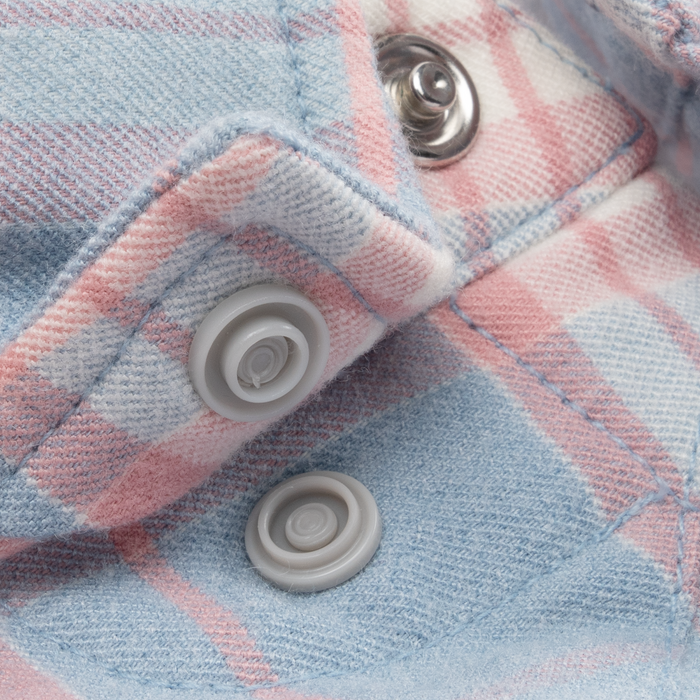 Close-up of soft fabric with snap buttons in pastel blue and pink tones on The Pacific City shirt.