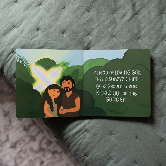 The Story of the Bible The Problem and the Promise Children's Book opened to Adam and Eve being kicked out of the garden page on a green blanket
