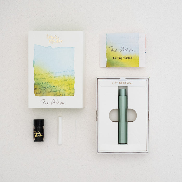 The Wren refillable everyday writing pen in Sage shown with the packaging – contents includes instruction book, 3ml fibre tip ink sample, ink reservoir and writing tip