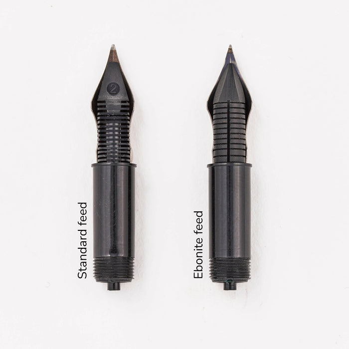 Side by side comparison of a standard injection moulded fountain pen feed and an ebonite feed