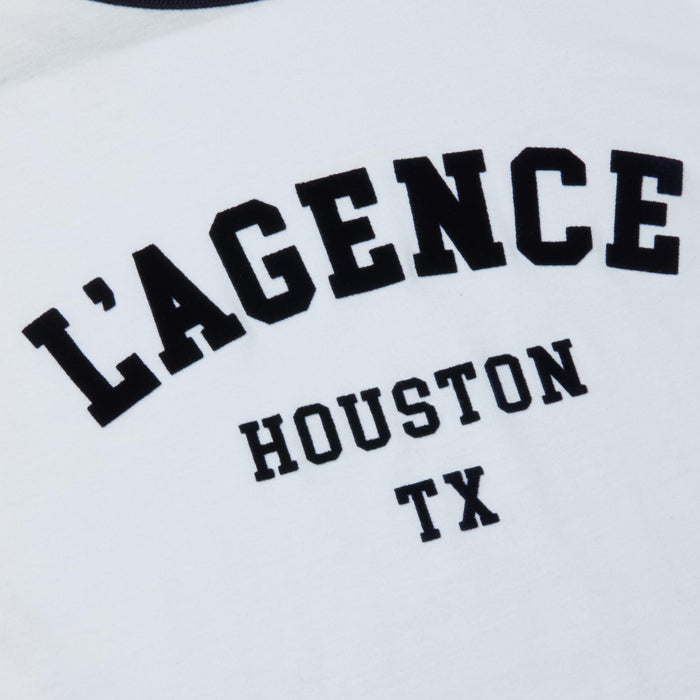 The Tommie Crewneck Tee is a white Houston t-shirt featuring bold black “LAGENCE” lettering above smaller “HOUSTON TX” text, crafted from soft Supima cotton in a relaxed fit.