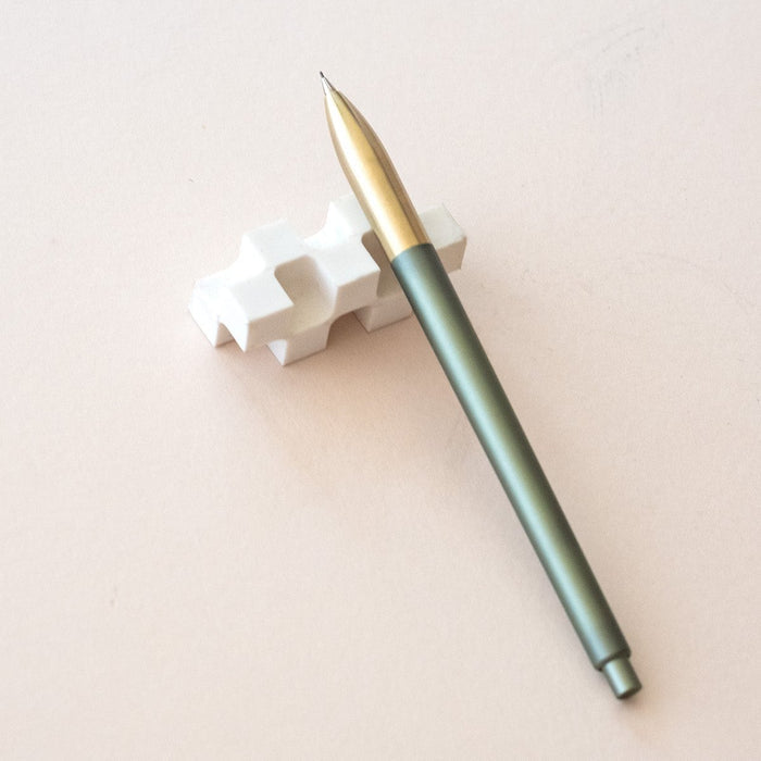 Tom's Studio Mechanical Pencil in Sage, resting on the World's Best Eraser