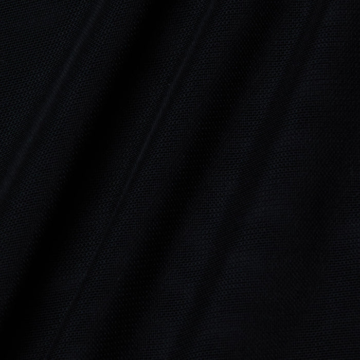 Close-up of the Trista Bodysuit’s black mesh fabric, showcasing its visible weave texture and diagonal folds that create subtle shadows and highlights across the surface.