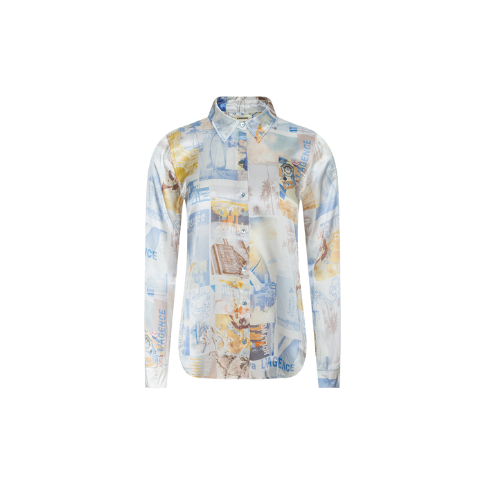 The Tyler Silk Blouse by L’AGENCE is a long-sleeve, button-down shirt crafted from silk, featuring a collage-style print in blue, beige, and white with assorted images and text.
