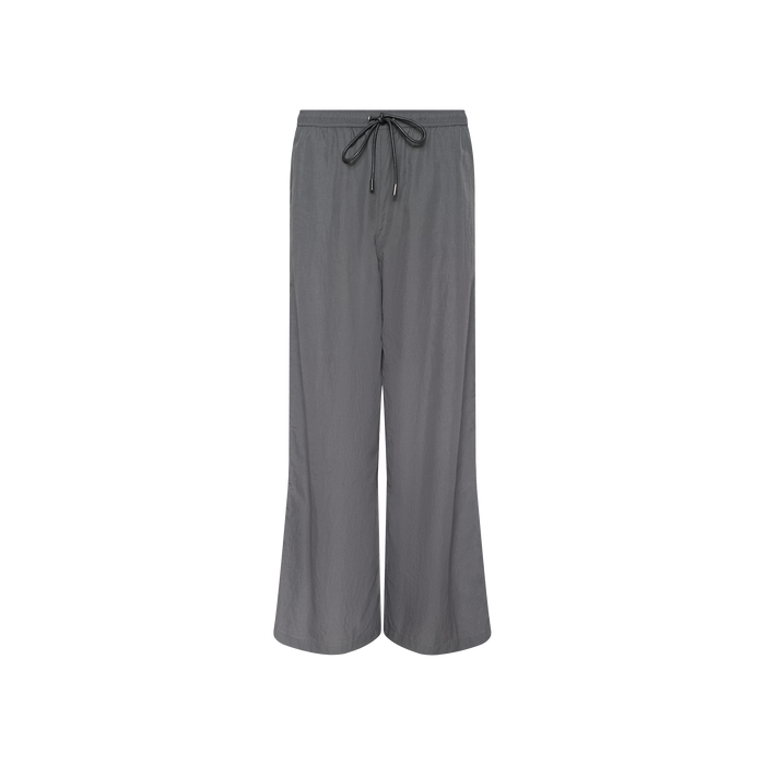 Valkyrie Snap Pant in gray features a wide-leg silhouette, drawstring and elastic waistband, and water-repellant fabric, shown against a plain white background.