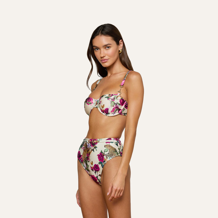 A woman poses in a rose leopard print bikini featuring the Vanessa High-Waisted Bikini Bottom and an underwire top against a plain, light background.