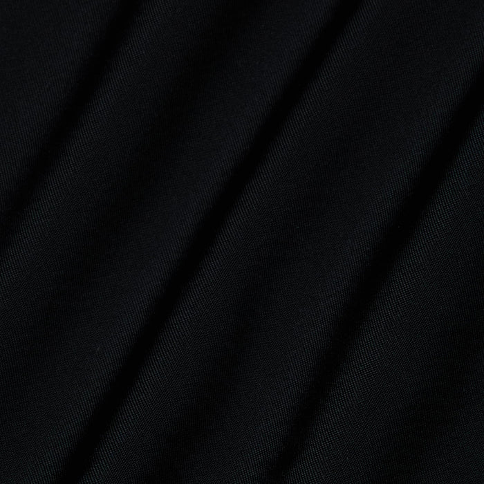 Close-up of the Violet String Bikini Bottom in black, featuring diagonal folds that reveal its smooth, slightly shiny texture and soft shadows between the creases.