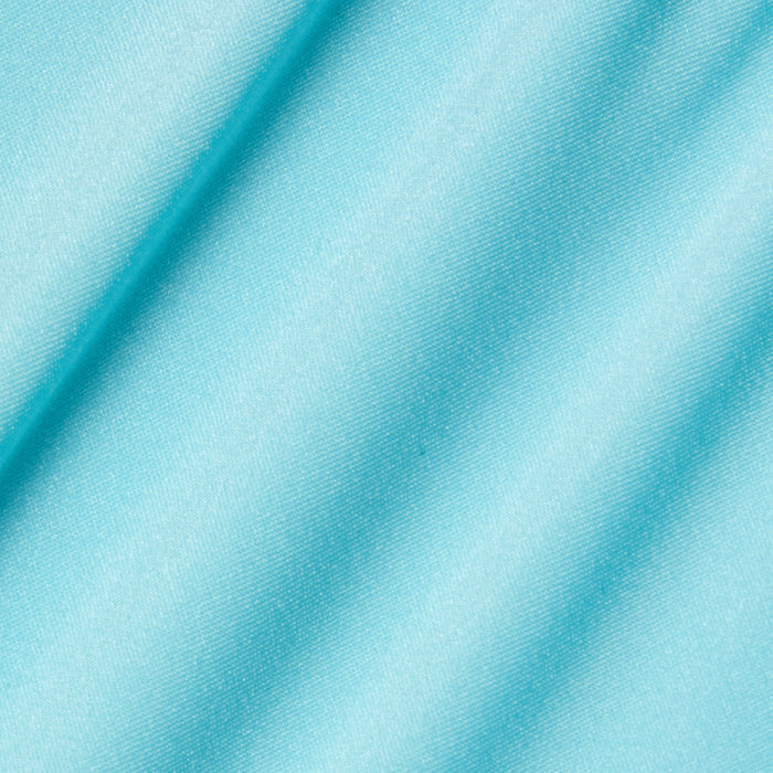 Close-up of the Violet String Bikini Bottom in an ice blue shade, featuring smooth fabric with a soft sheen and diagonal folds that create gentle shadows across the material.