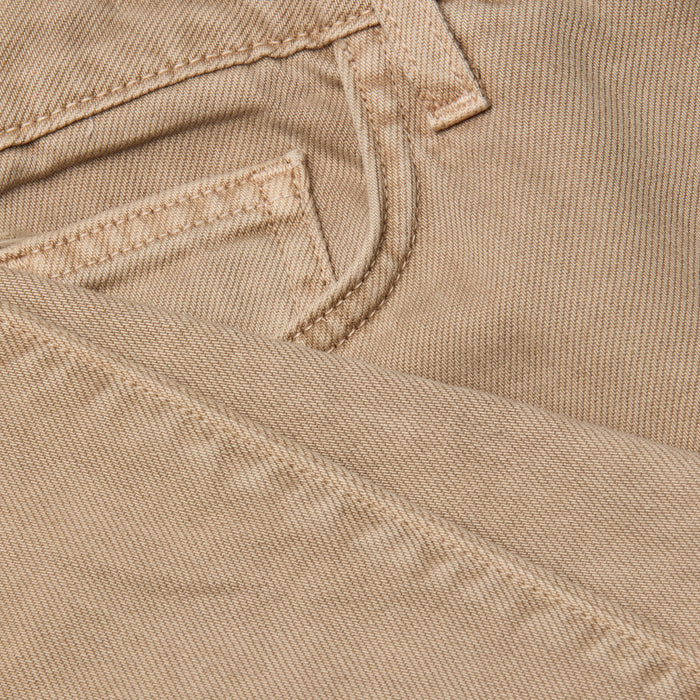 Close-up of the neutral tan denim fabric of the Wanda Cropped Wide-Leg Jean, highlighting a jeans pocket and detailed stitching, with one section of the material folded over the other.