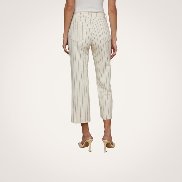 A woman stands facing away, wearing the Wanda Cropped Wide-Leg Pant in a cream nautical stripe and beige high heels against a plain background.