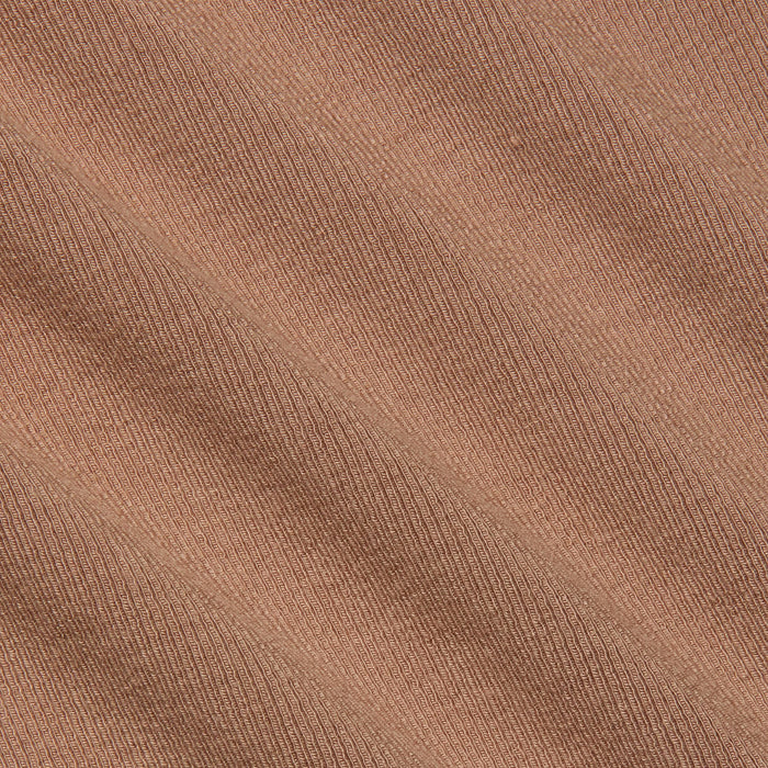 Close-up of the Wrenna Racerback Bodysuit’s light brown rib fabric, featuring fine, evenly spaced diagonal ridges and visible texture. The material showcases a subtle pattern with soft shadow effects across its surface.