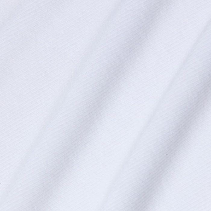 Close-up of the Wrenna Racerback Bodysuit’s white rib fabric, featuring soft diagonal folds and a subtle textured pattern that creates gentle shadows and highlights across the surface.
