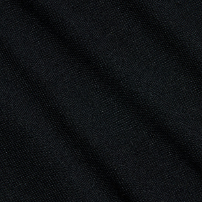 Close-up of the Wrenna Racerback Bodysuit in black, featuring fine ribbed fabric with subtle diagonal textured lines and soft folds. The lighting accentuates the material’s delicate sheen and detailed pattern.